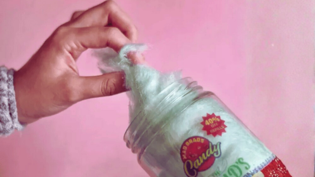 hand holding cotton candy pink